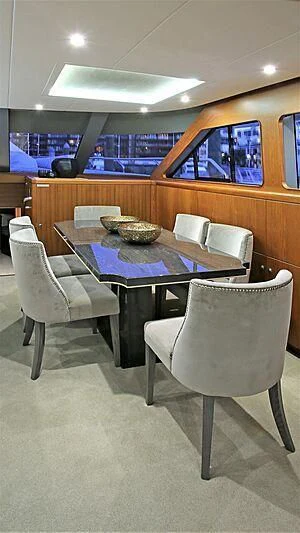 a table with chairs around it aboard BELLE VIE Yacht for Sale