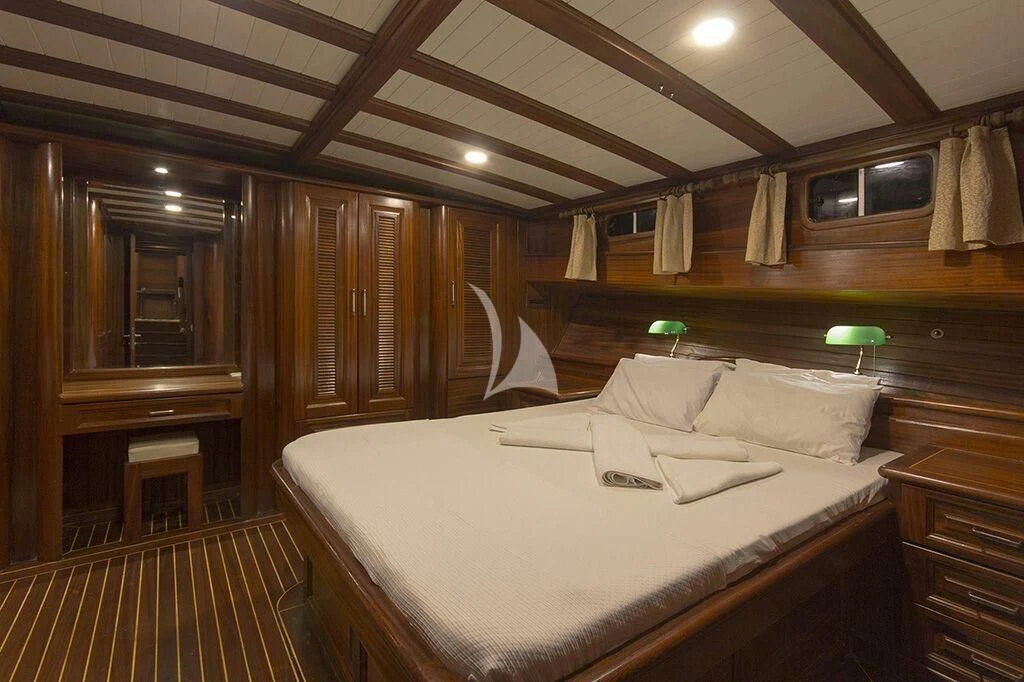 a bed with a white sheet aboard DREAMLAND Yacht for Sale