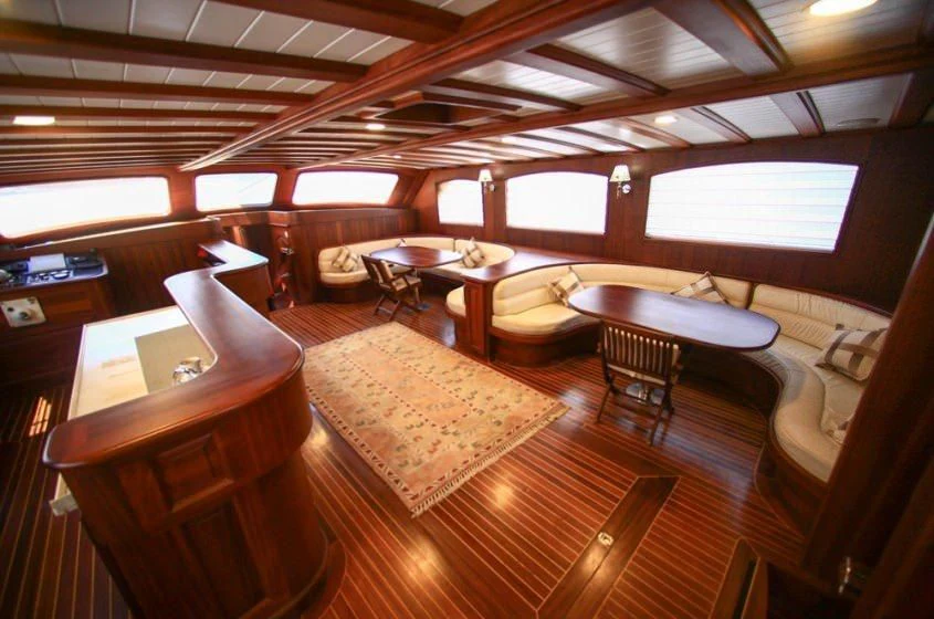 a room with a bed and desk aboard DREAMLAND Yacht for Sale