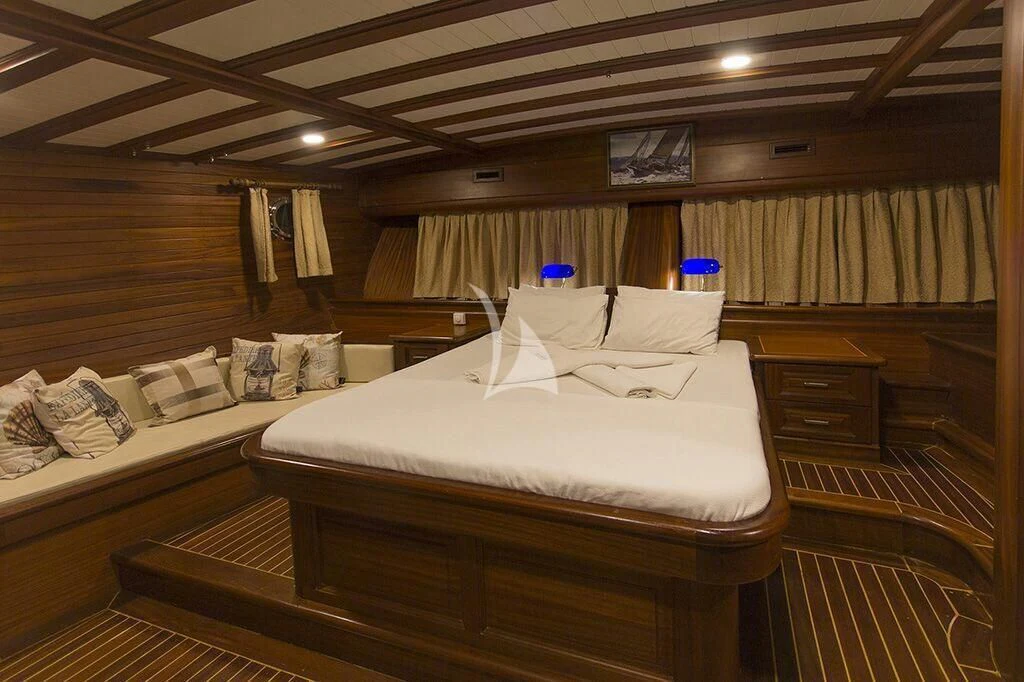a room with a bed and a television aboard DREAMLAND Yacht for Sale