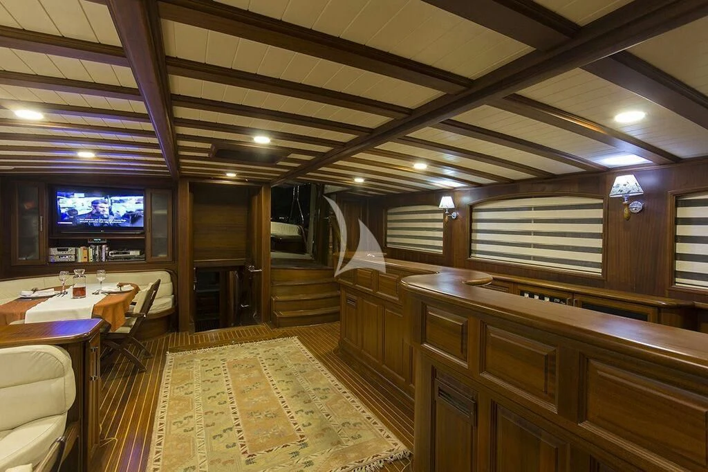 a room with a tv and tables aboard DREAMLAND Yacht for Sale