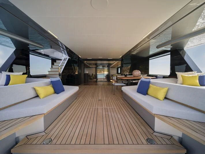 a room with a wood floor and a couch and a large window aboard TELL ME WHY Yacht for Sale