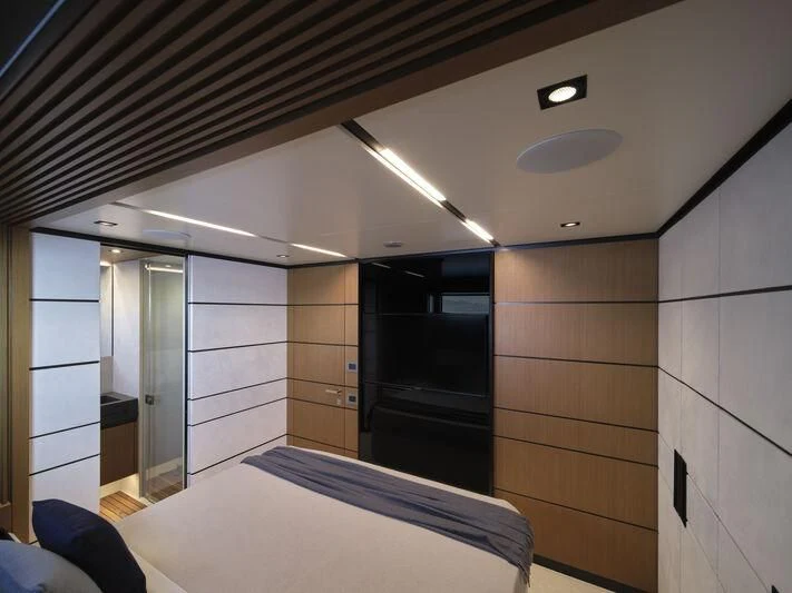 a room with a bed and a large mirror aboard TELL ME WHY Yacht for Sale