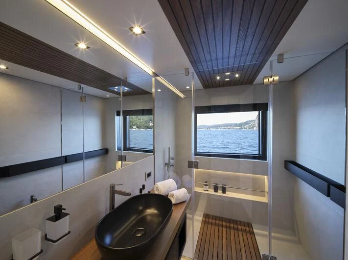 a bathroom with a tub sink and a sink aboard TELL ME WHY Yacht for Sale