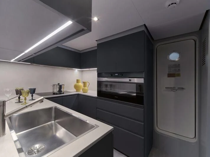 a kitchen with a sink and refrigerator aboard TELL ME WHY Yacht for Sale