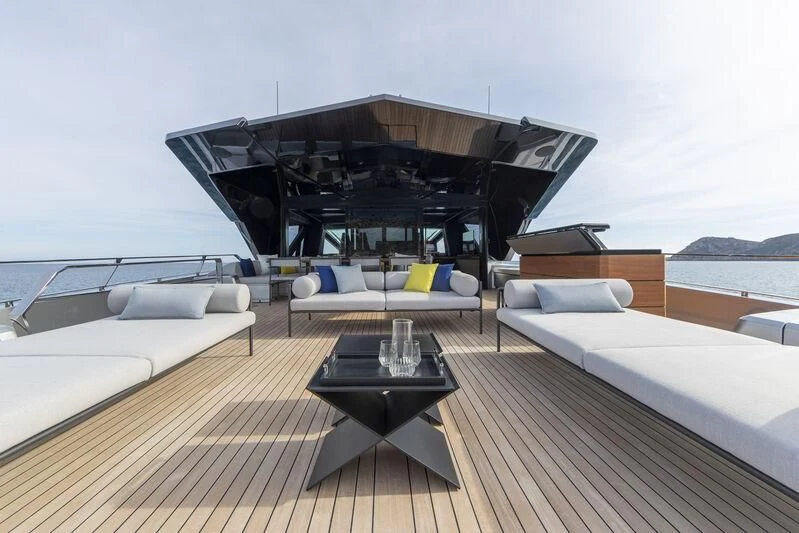 a room with a table and couches aboard TELL ME WHY Yacht for Sale