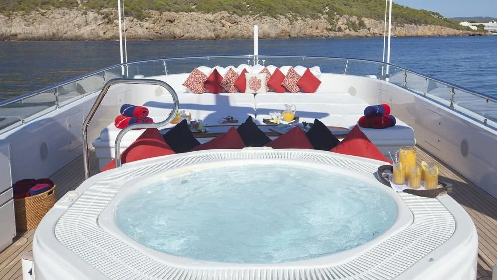 a boat with red and white flags on it aboard BIG CHANGE II Yacht for Sale