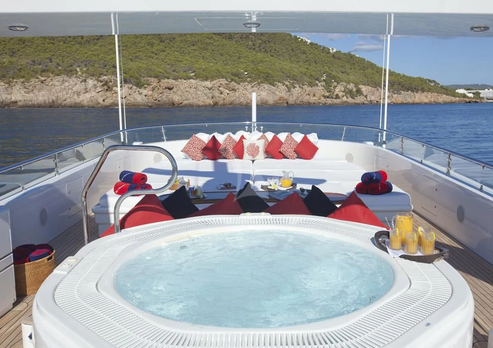 a boat with red and white flags on it aboard BIG CHANGE II Yacht for Sale