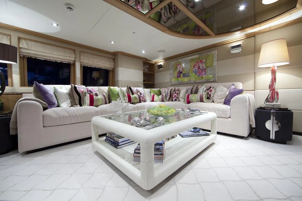 a living room with a couch and a table aboard BIG CHANGE II Yacht for Sale