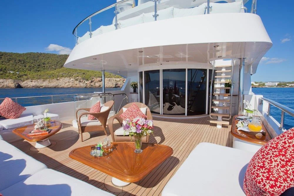 a table and chairs on a deck aboard BIG CHANGE II Yacht for Sale