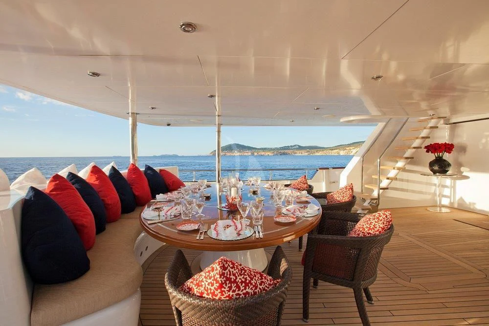 a room with a table and chairs aboard BIG CHANGE II Yacht for Sale