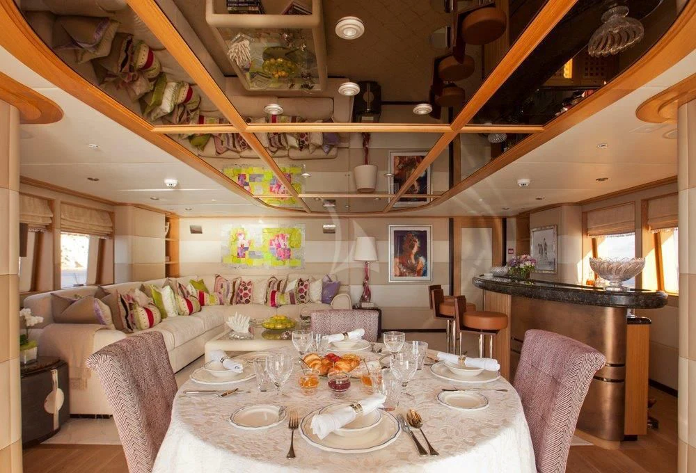 a large living room with a dining table and chairs aboard BIG CHANGE II Yacht for Sale