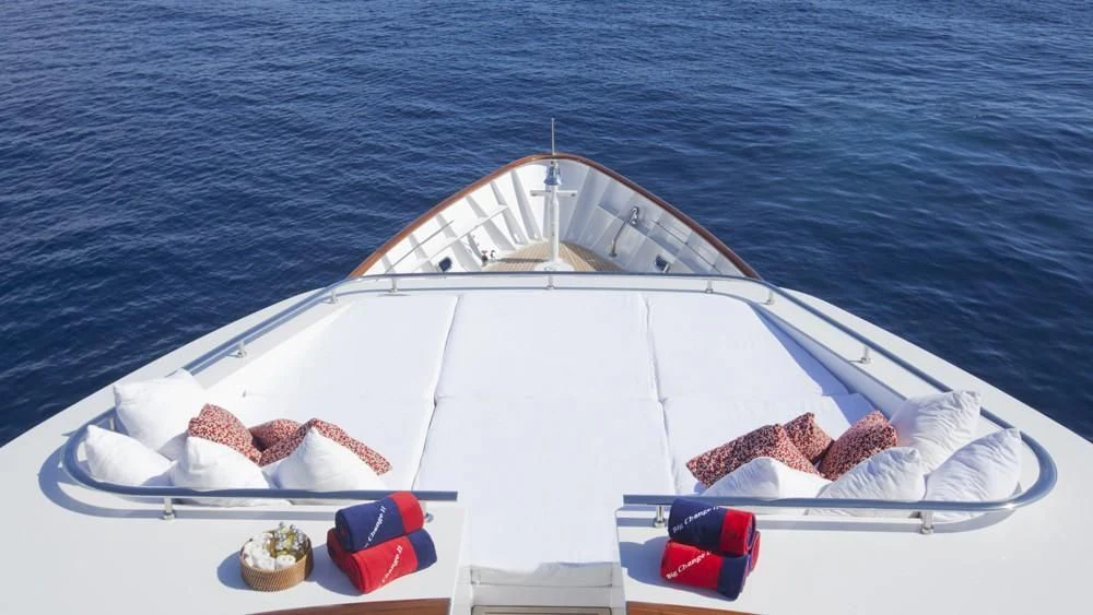 a white boat with a red seat on the front aboard BIG CHANGE II Yacht for Sale