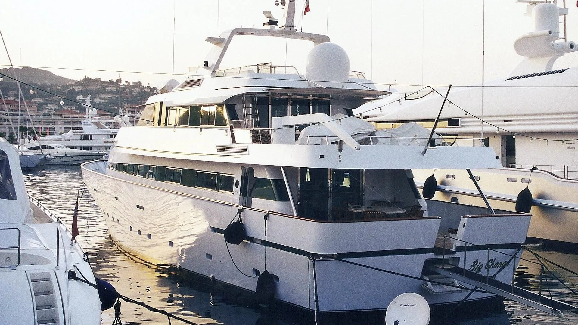 a large white boat in a harbor aboard BIG CHANGE II Yacht for Sale