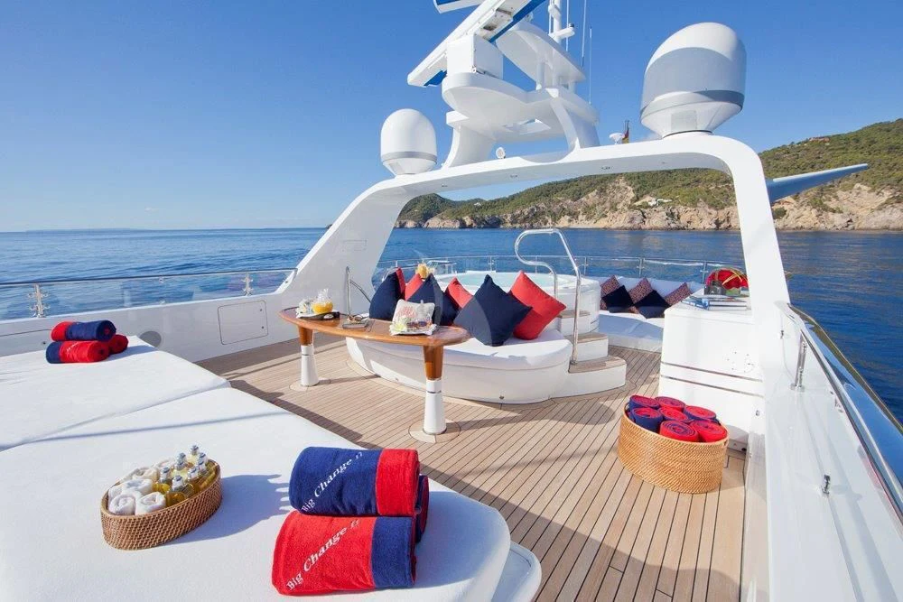 a deck with a picnic table and chairs on it aboard BIG CHANGE II Yacht for Sale