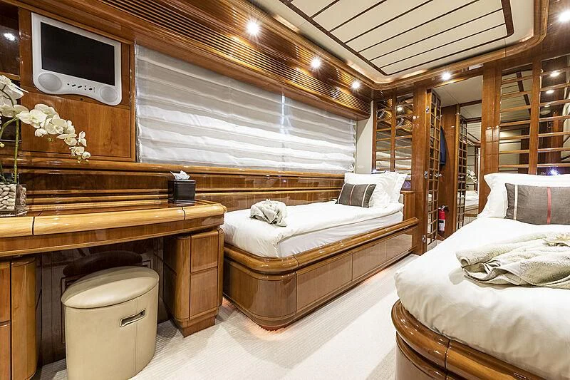 a room with two beds and a tv aboard SETAI Yacht for Sale