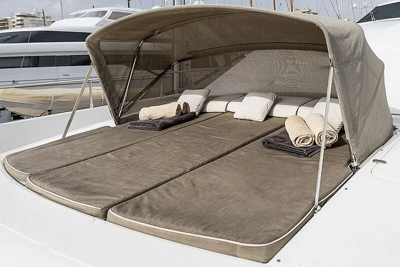a cat lying on a bed aboard SETAI Yacht for Sale