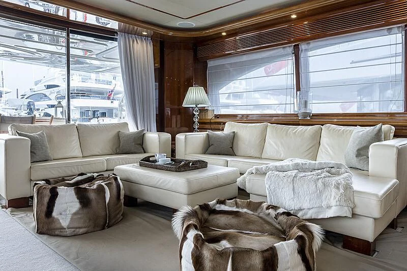 a dog sitting on a couch in a living room aboard SETAI Yacht for Sale