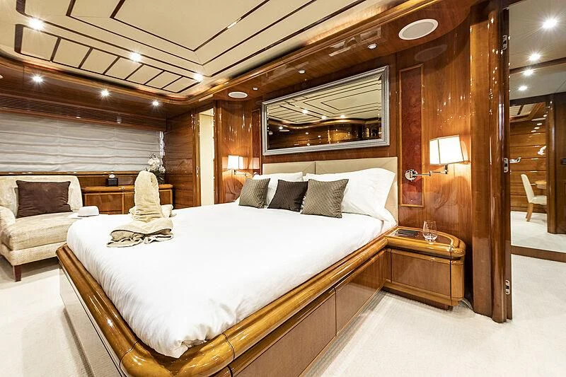 a room with a bed and a chair aboard SETAI Yacht for Sale