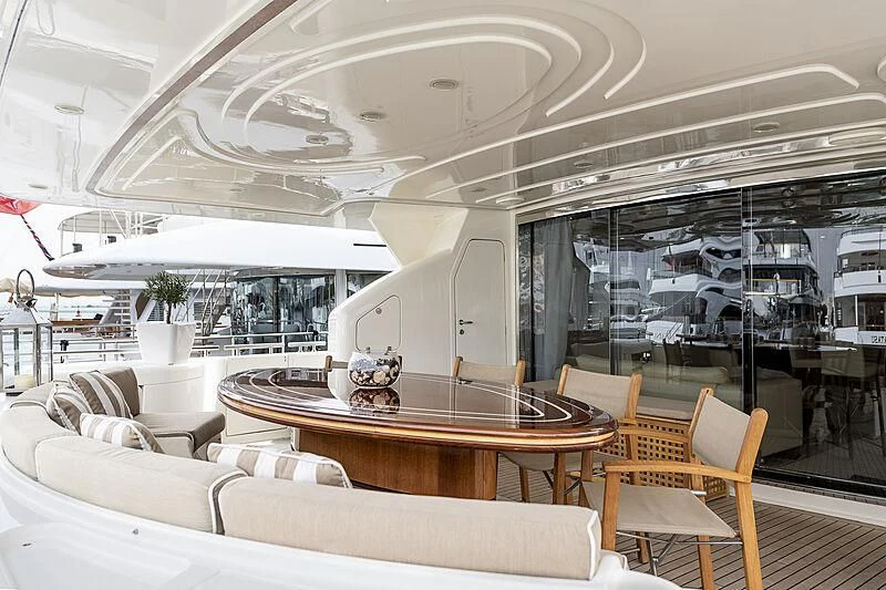 a room with a table chairs and a large window aboard SETAI Yacht for Sale