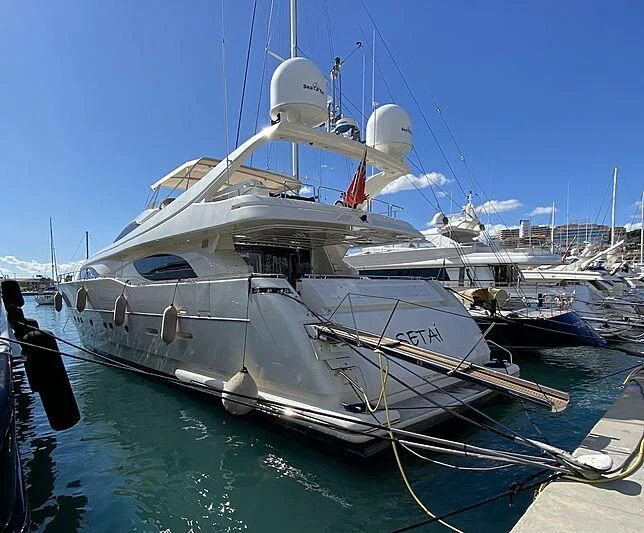 a large white boat in a harbor aboard SETAI Yacht for Sale
