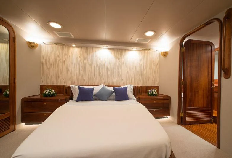 a bed with white sheets and pillows aboard GOLDEN OSPREY Yacht for Sale