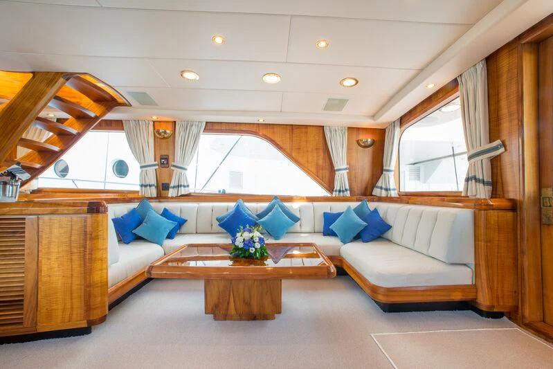 a room with a couch and a table aboard GOLDEN OSPREY Yacht for Sale