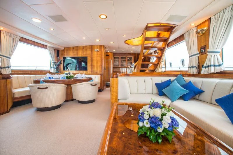 a living room with a couch and a table aboard GOLDEN OSPREY Yacht for Sale