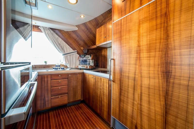 a kitchen with wooden cabinets aboard GOLDEN OSPREY Yacht for Sale