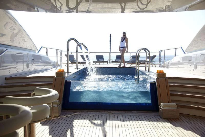 a person standing on a deck of a boat aboard HIGH POWER III Yacht for Sale