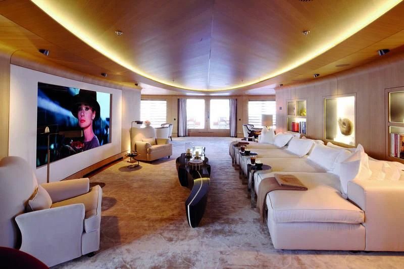 a large living room with a large screen aboard HIGH POWER III Yacht for Sale