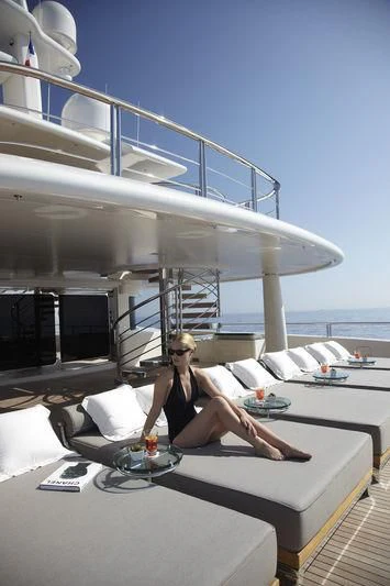 a person sitting on a couch aboard HIGH POWER III Yacht for Sale