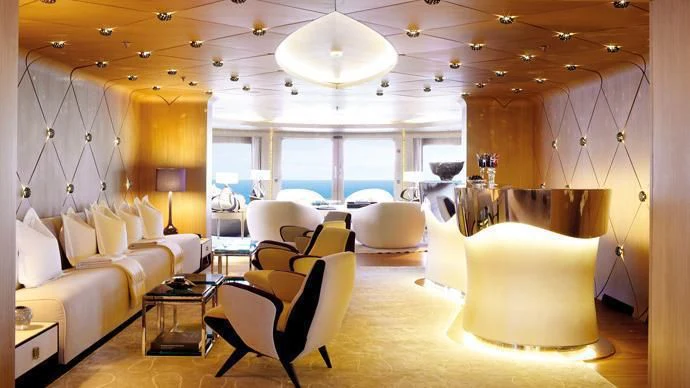 a room with a couch and a table and chairs aboard HIGH POWER III Yacht for Sale