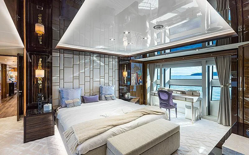 a room with a bed and a chair aboard THE BOAT OF FATE 2 Yacht for Sale