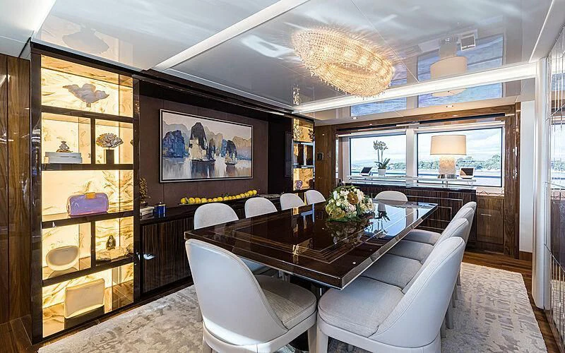 a living room with a large glass table and chairs aboard THE BOAT OF FATE 2 Yacht for Sale