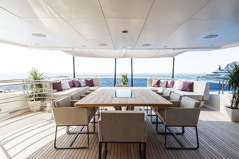 a room with a table and chairs aboard THE BOAT OF FATE 2 Yacht for Sale