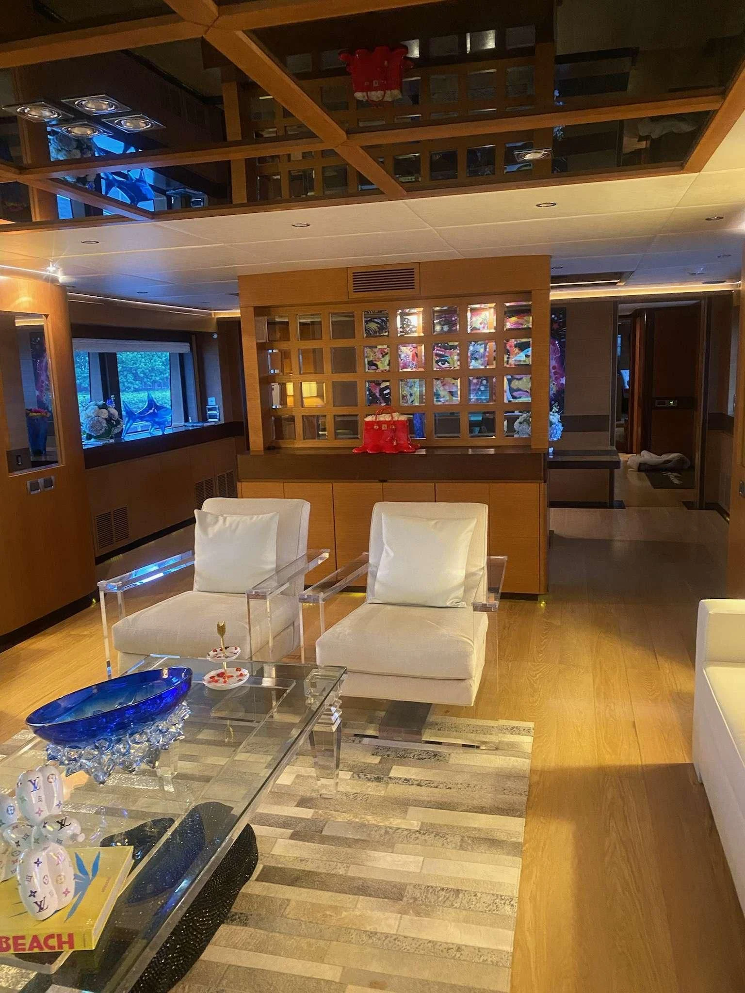 a living room with a large glass table aboard KIMBERLIE Yacht for Sale
