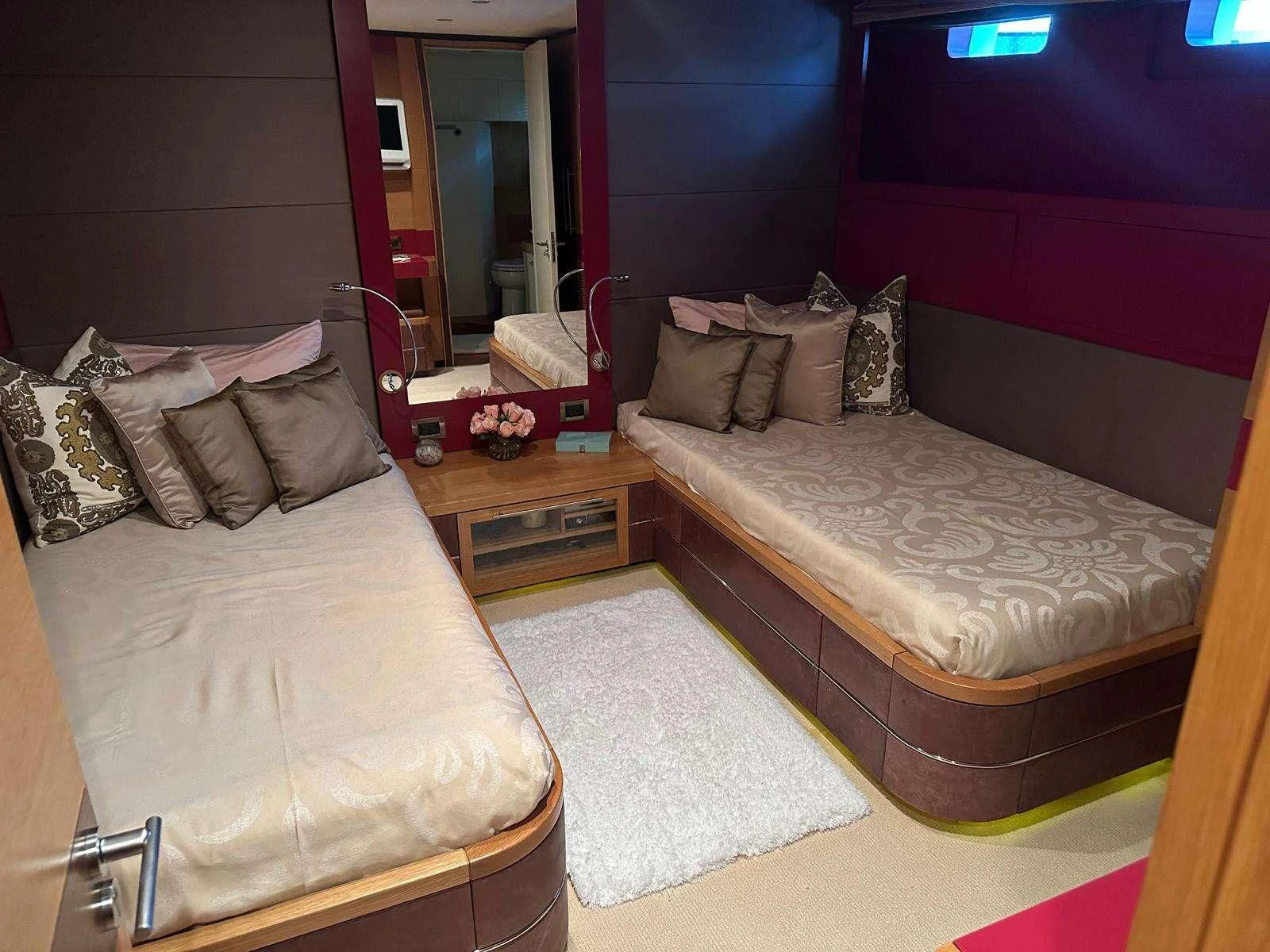 a bedroom with a bed and a mirror aboard KIMBERLIE Yacht for Sale