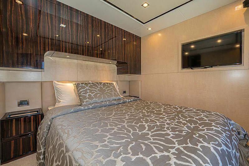 a bed with a white comforter aboard PHOENIX Yacht for Sale