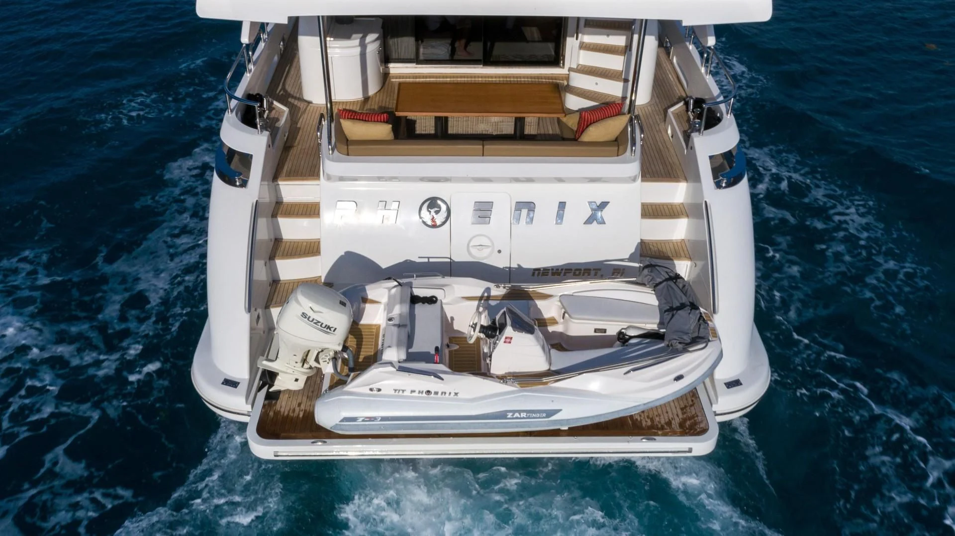 a white boat on the water aboard PHOENIX Yacht for Sale