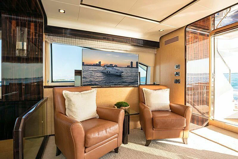 a living room with a large screen aboard PHOENIX Yacht for Sale