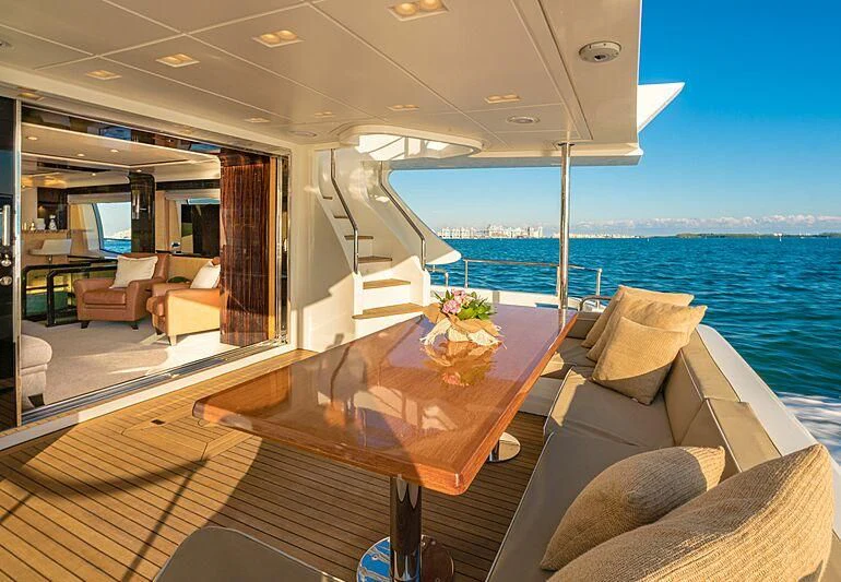 a living room with a large balcony overlooking the ocean aboard PHOENIX Yacht for Sale