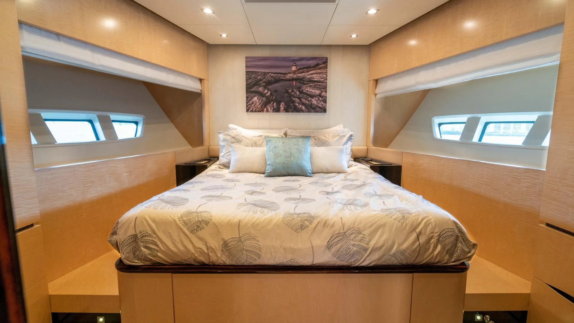 a bed with a white comforter aboard PHOENIX Yacht for Sale