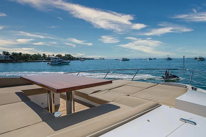 a wooden bench overlooking a body of water aboard PHOENIX Yacht for Sale