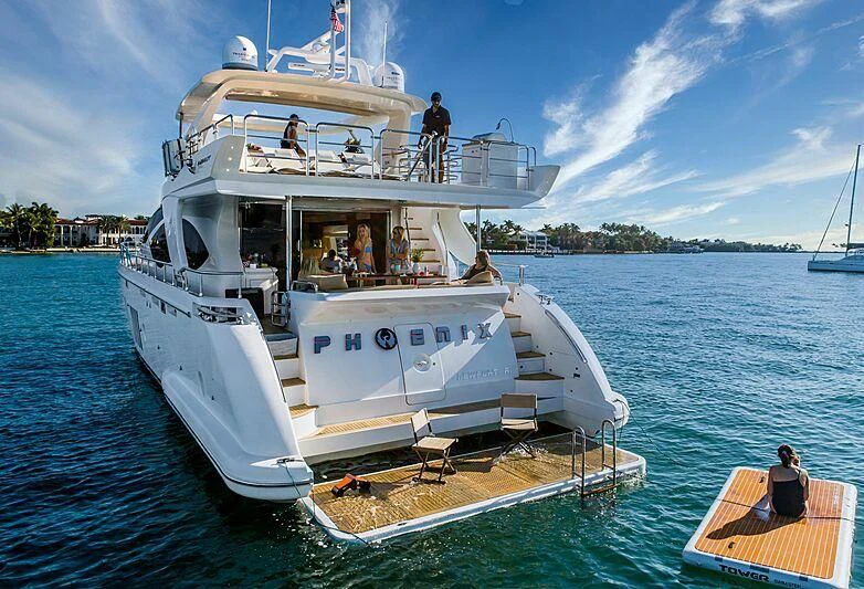 a large white boat with people on it aboard PHOENIX Yacht for Sale