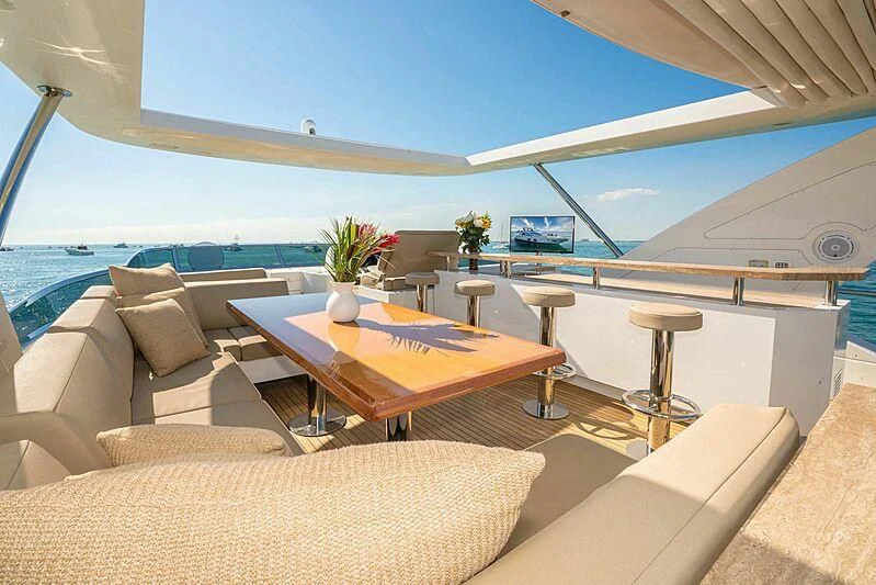 a room with a couch and a table and chairs aboard PHOENIX Yacht for Sale