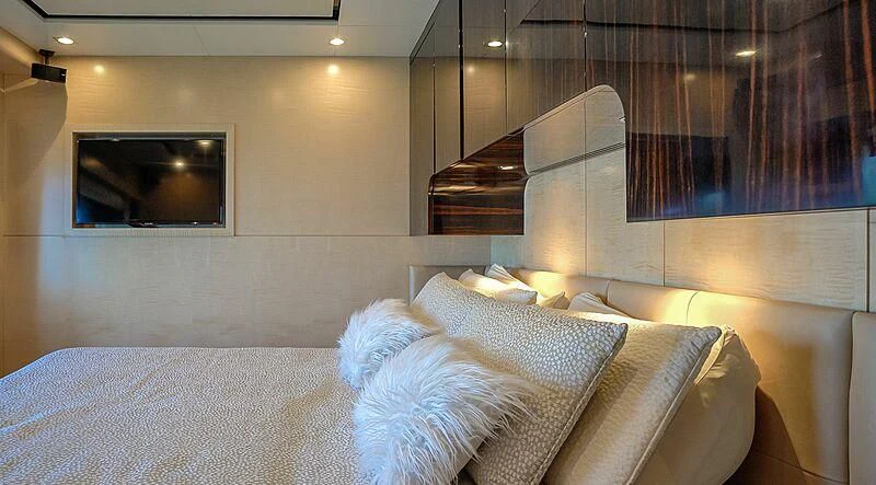 a bed with a white bed spread aboard PHOENIX Yacht for Sale