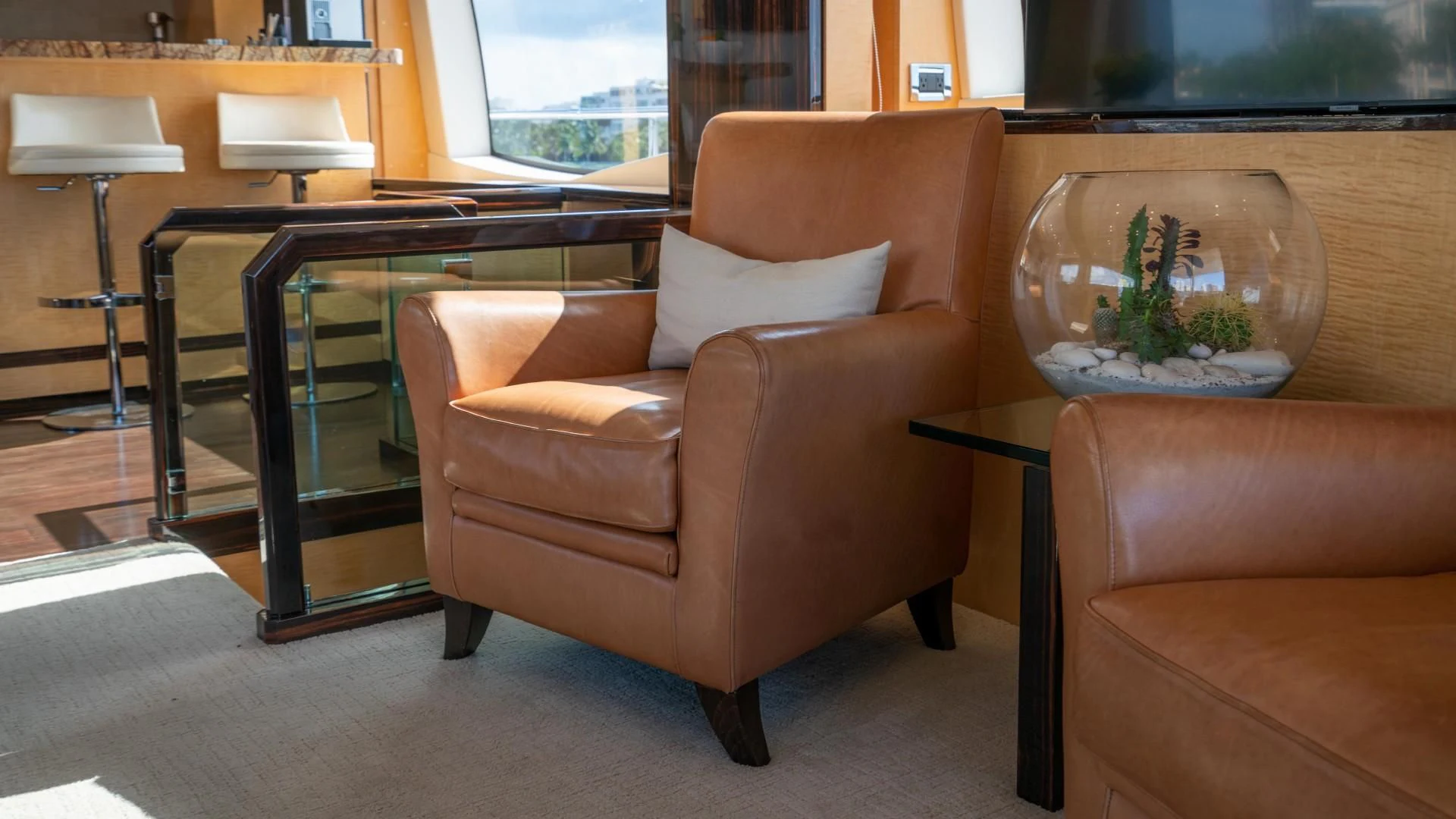 a brown leather chair in a room aboard PHOENIX Yacht for Sale