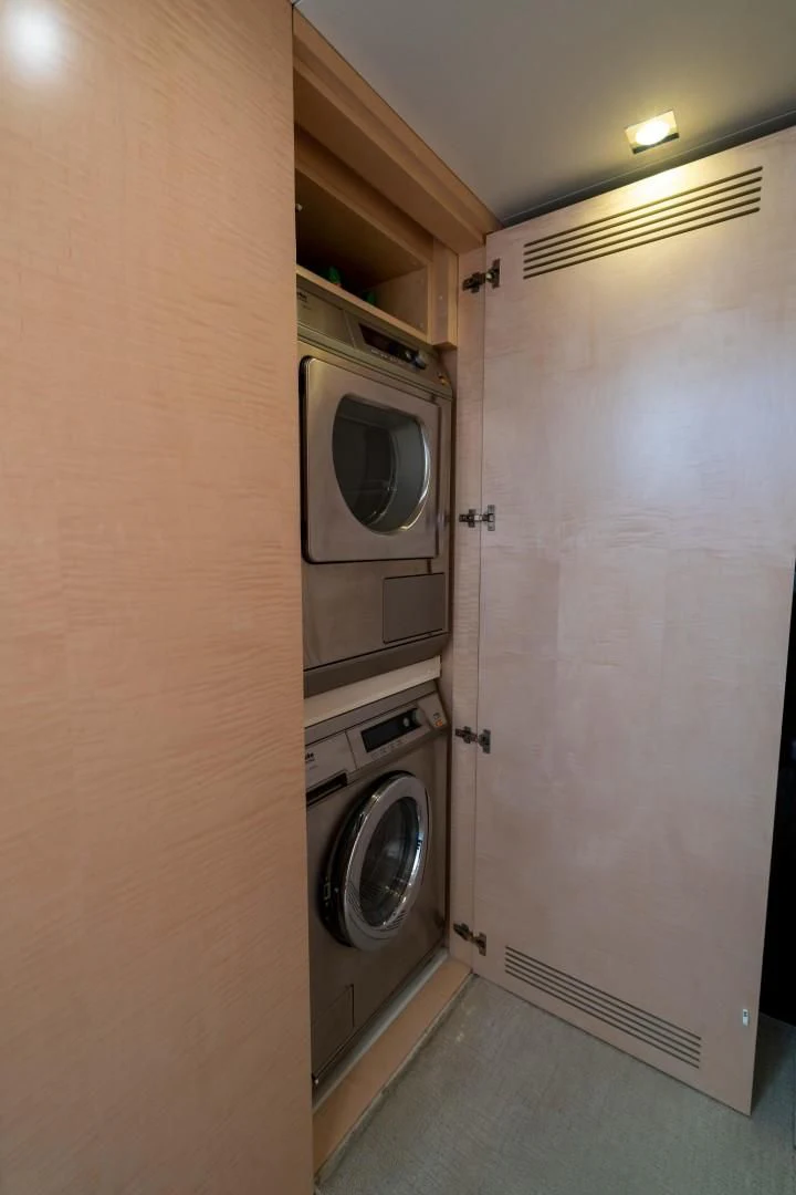 a closet with a washer and dryer in it aboard PHOENIX Yacht for Sale