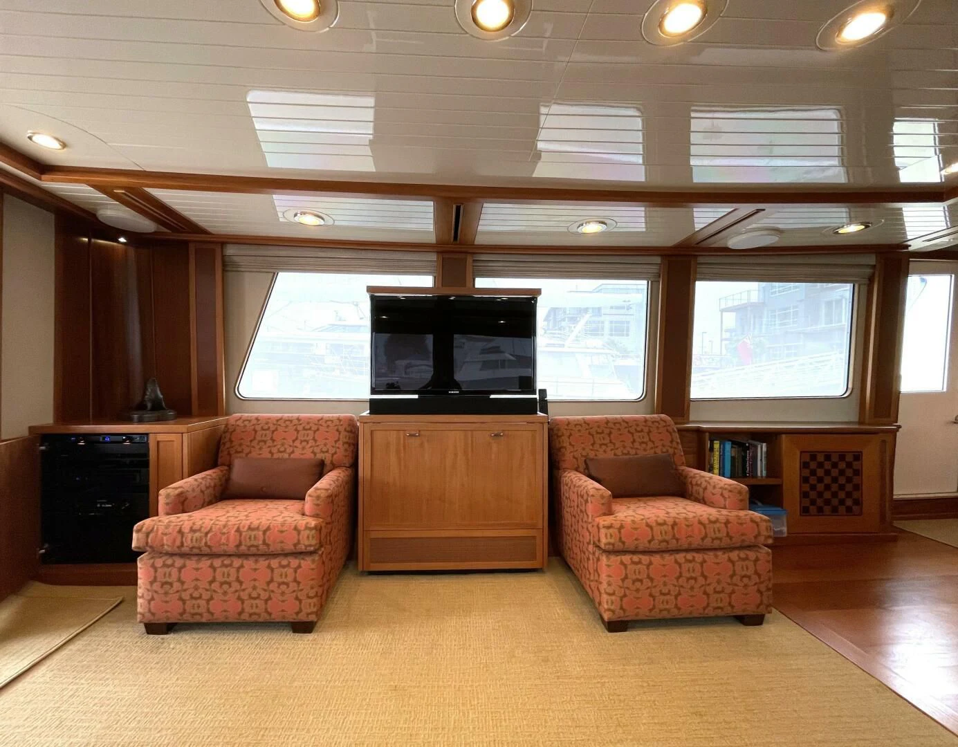 a living room with a tv and a fireplace aboard SEA LION Yacht for Sale